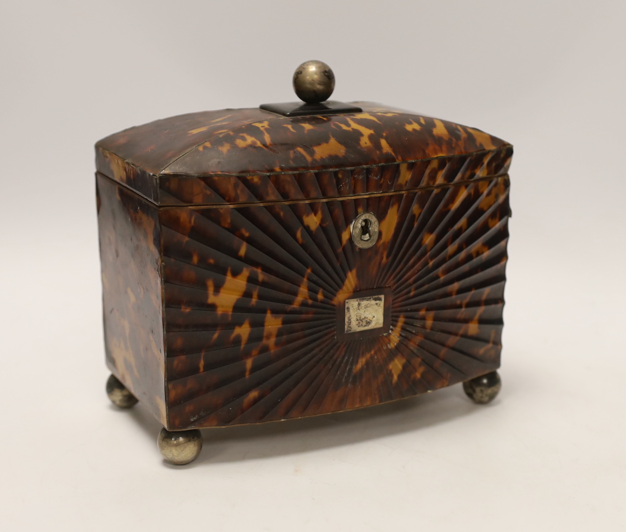 A Regency tortoiseshell tea caddy, with fluted paterae bowfront, 17cm high, 18cm wide, 10cm deep